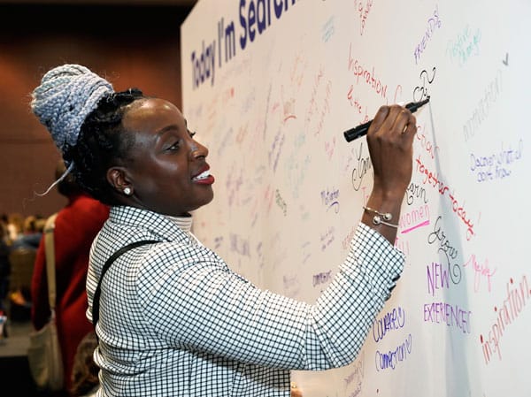 attendee exploring the signing wall at the 2023 CA Conference for Women